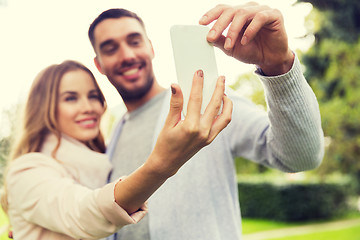 Image showing close up of couple with smartphone taking selfie