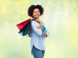 Image showing smiling afro american woman with shopping bags