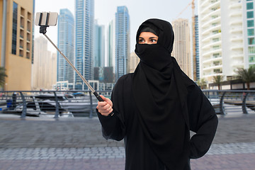 Image showing muslim woman in hijab taking selfie by smartphone