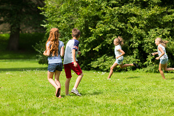 Image showing group of happy kids or friends playing outdoors