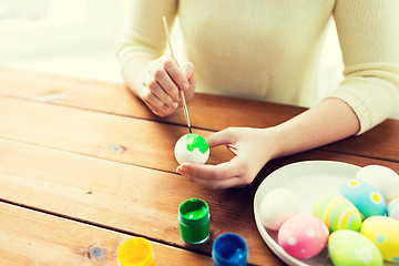 Image showing close up of woman hands coloring easter eggs