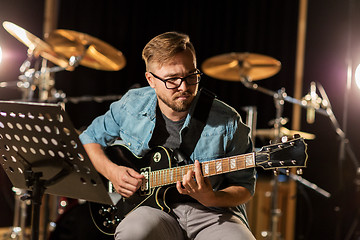 Image showing man playing guitar at studio rehearsal