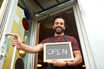 Image showing man or waiter with blackboard at bar entrance door