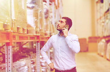 Image showing serious man calling on smartphone at warehouse