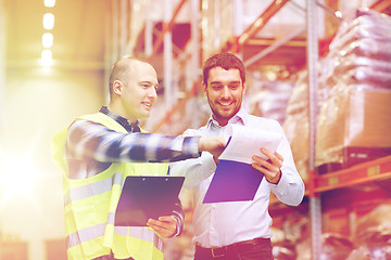 Image showing worker and businessmen with clipboard at warehouse