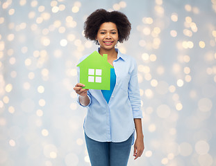 Image showing happy african american woman with green house icon