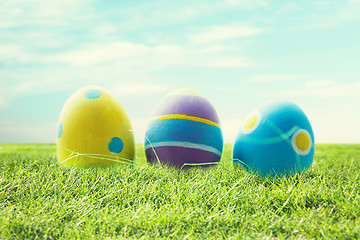 Image showing close up of colored easter eggs on grass