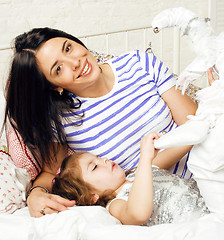 Image showing mother with daughter together in bed smiling, happy family close up, lifestyle people concept, cool real modern family 
