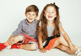 Image showing little cute boy and girl hugging playing on white background, happy smiling family, lifestyle people concept 