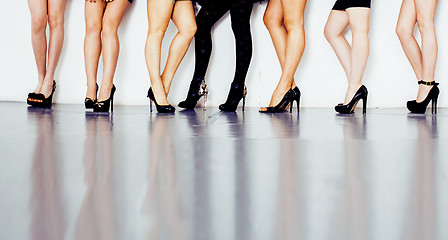 Image showing diverse type pair of woman legs in hight heels black shoes isolated on white background and floor, diversity people lifestyle concept