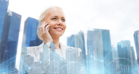 Image showing happy businesswoman calling on smartphone in city