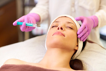 Image showing beautician doing beauty injection to woman lips