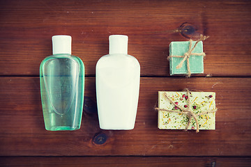 Image showing close up of handmade soap bars and lotions on wood