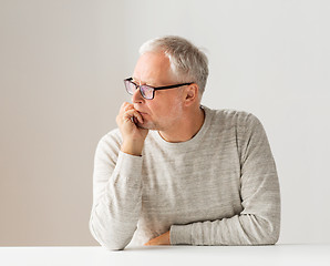 Image showing close up of senior man in glasses thinking