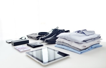 Image showing clothes, gadgets and business stuff on table