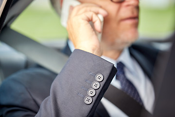 Image showing senior businessman calling on smartphone in car