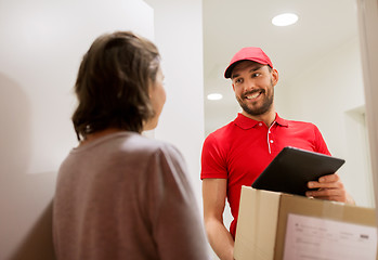 Image showing deliveryman with tablet pc and box at customer