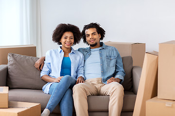 Image showing happy couple with boxes moving to new home