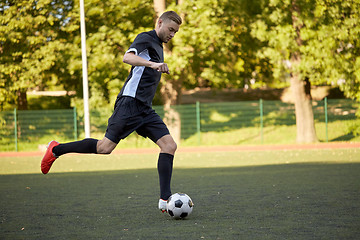 Image showing soccer player playing with ball on football field