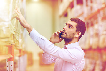 Image showing serious man calling on smartphone at warehouse