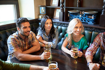 Image showing friends with beer watching football at bar or pub