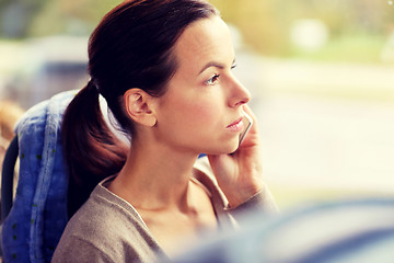 Image showing woman in travel bus calling on smartphone