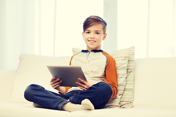 Image showing smiling boy with tablet computer at home