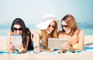 Image showing happy young women with tablet pc on summer beach