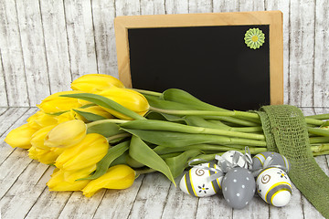 Image showing Beautiful flowers and blank blackboard