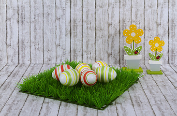 Image showing Colorful easter eggs with decorative wooden flowers 
