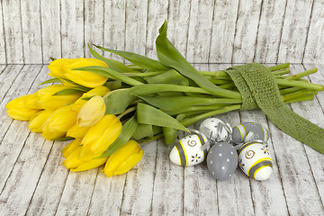 Image showing Beautiful yellow tulips with easter eggs