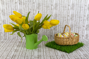 Image showing Yellow tulips in green watering can