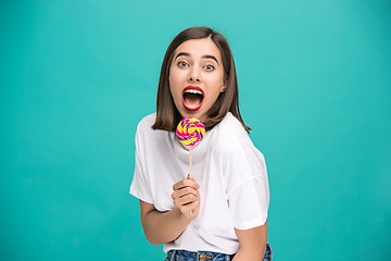 Image showing The young woman with colorful lollipop