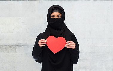 Image showing muslim woman in hijab holding red heart