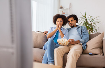 Image showing couple with popcorn watching tv at home