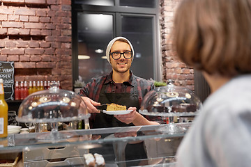 Image showing man or barman with cake serving customer at cafe