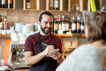 Image showing man or waiter serving customer at bar