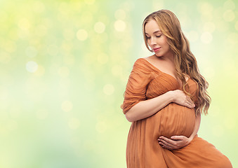 Image showing happy pregnant woman touching her big belly