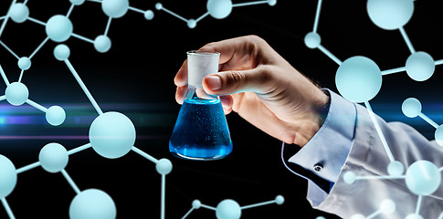 Image showing close up of scientist holding flask with chemical