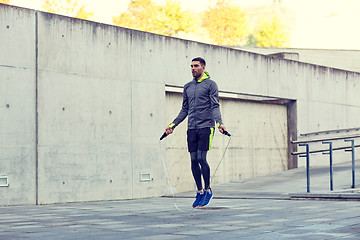 Image showing man exercising with jump-rope outdoors