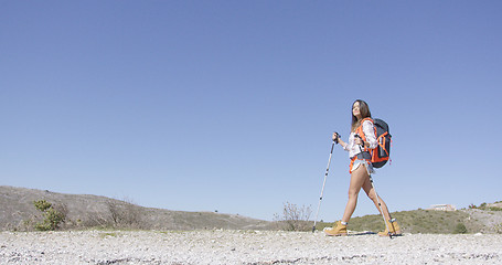 Image showing Young female tourist walking