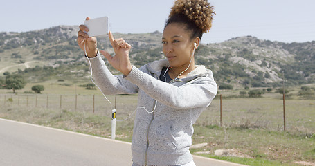 Image showing Young woman taking picture of nature