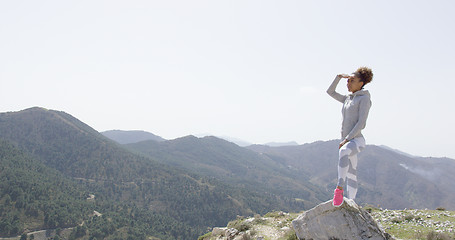 Image showing Young sportive woman looking around