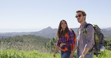 Image showing Young couple walking in mountains