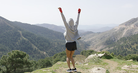 Image showing Young successful boxer on top of mountain