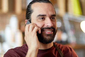 Image showing close up of man or waiter calling on smartphone