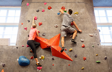 Image showing man and woman exercising at indoor climbing gym