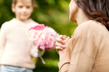 Image showing happy woman and girl with flowers outdoors