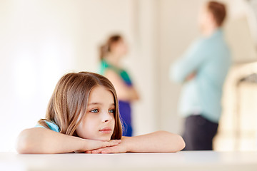 Image showing beautiful sad girl and parents arguing at home