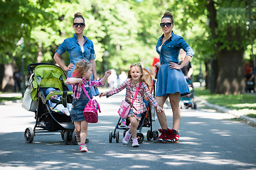 Image showing twins mother with children  in city park